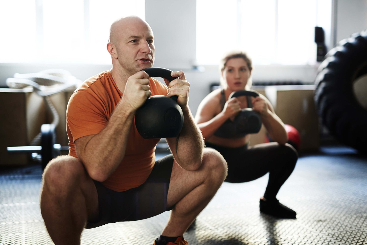 Man and woman with kettlebell